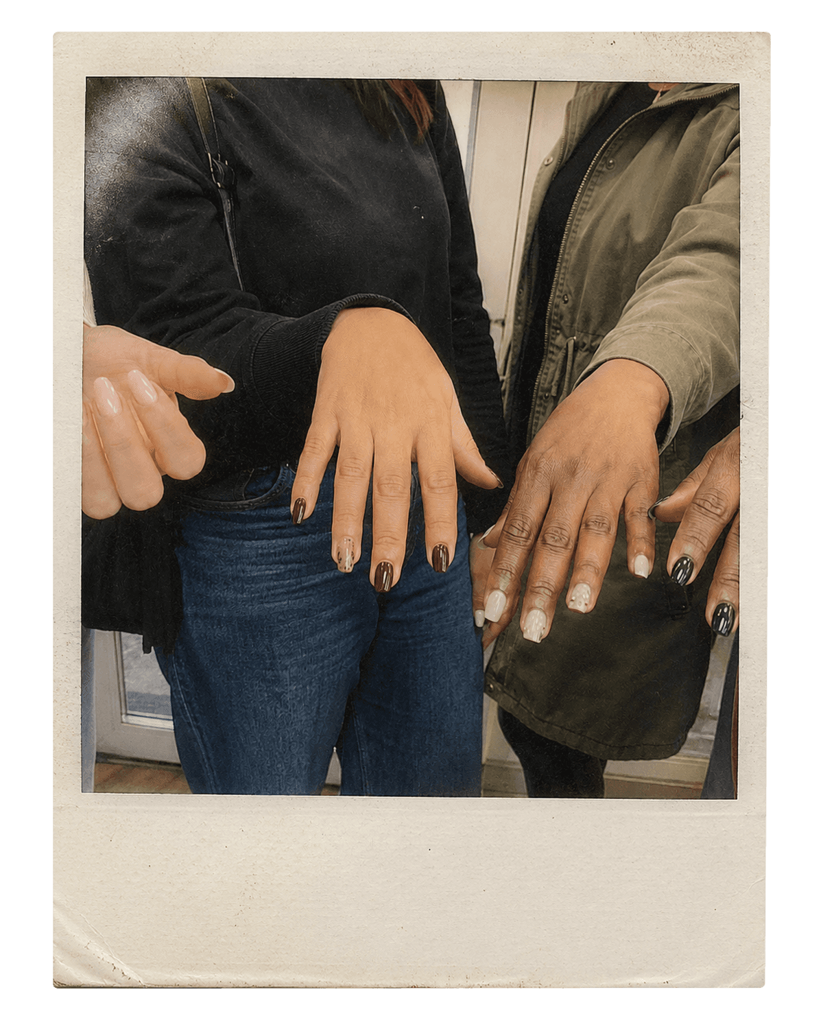 Vintage instant photo of four friends showing their fresh manicures outside the studio.