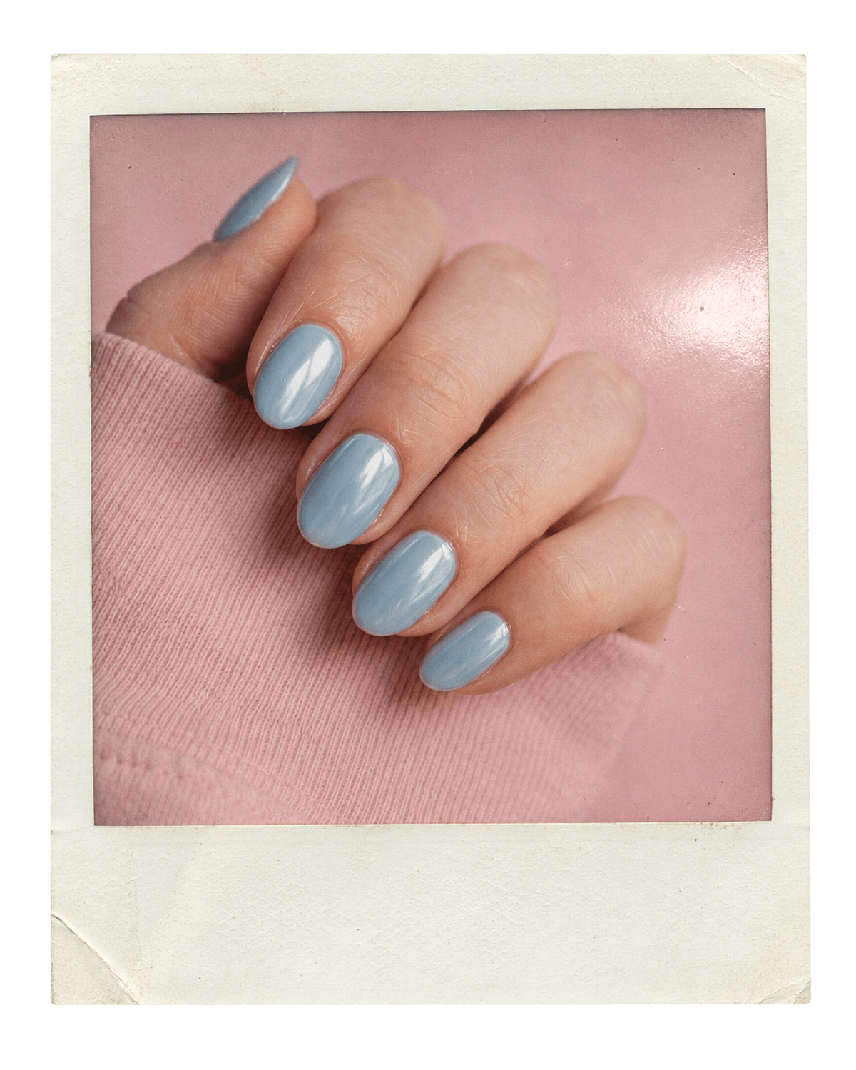 Vintage instant photo of almond baby-blue chrome nails against a pink sleeve.